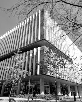 Black and white photo of a building with trees